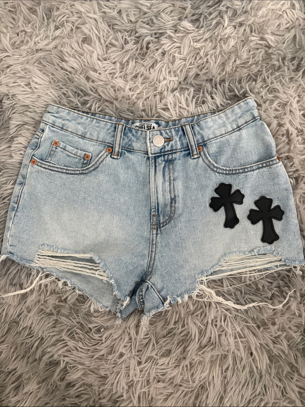 Light Wash Denim Cutoff Shorts with Black Cross Patches